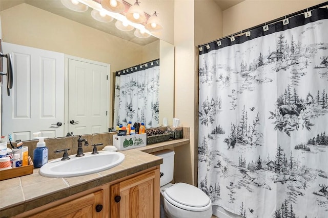 bathroom with vanity, toilet, walk in shower, and a chandelier