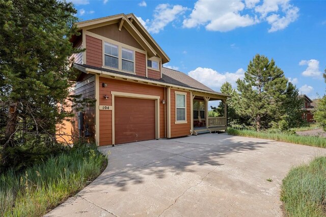 view of front of home with a porch and a garage