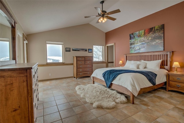 bedroom with lofted ceiling, light tile patterned floors, baseboards, and a ceiling fan