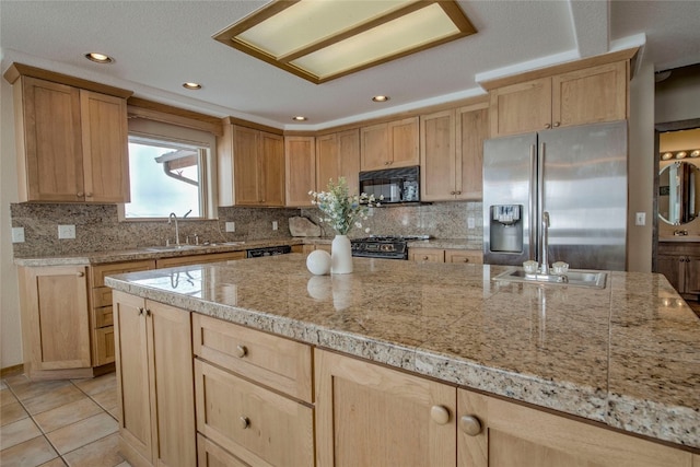 kitchen featuring black microwave, a sink, stainless steel fridge with ice dispenser, and light brown cabinetry