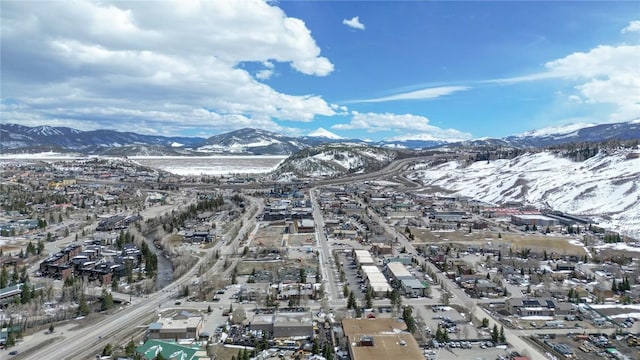 snowy aerial view featuring a mountain view