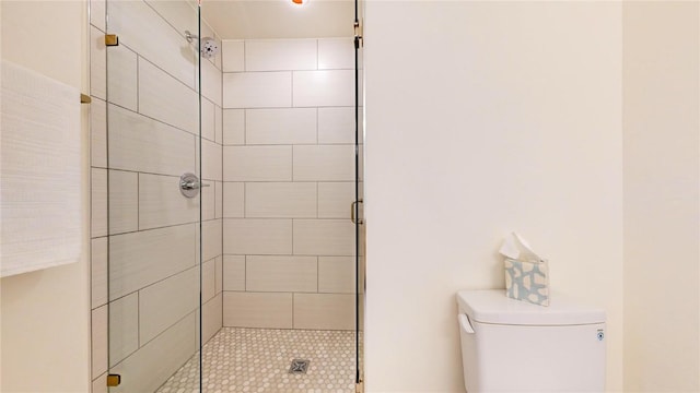 bathroom featuring a shower stall and toilet