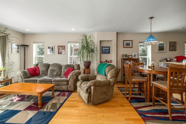 living room featuring light wood-style floors, a chandelier, and recessed lighting