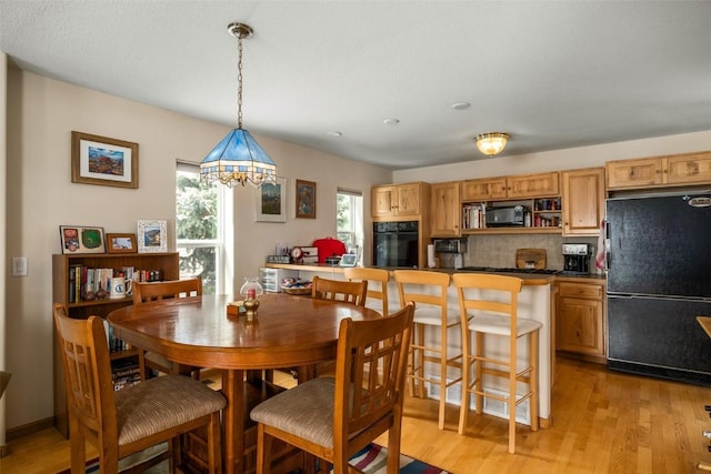 dining space with light wood finished floors