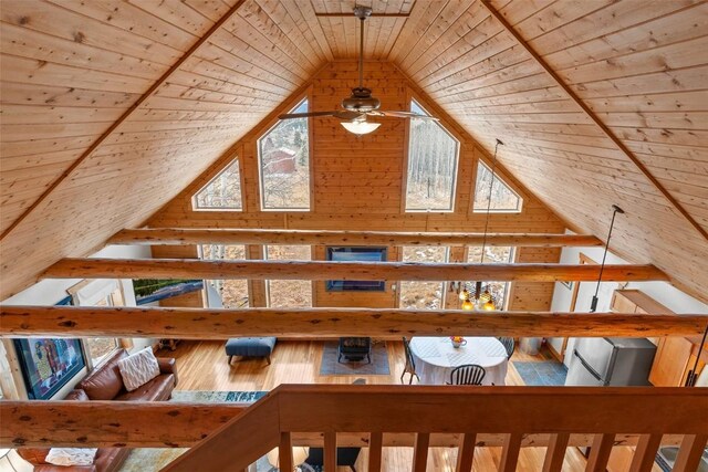 bonus room with wood-type flooring, lofted ceiling with beams, ceiling fan, and wood ceiling