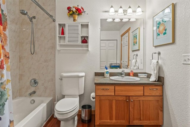 full bathroom featuring toilet, vanity, and shower / tub combo with curtain