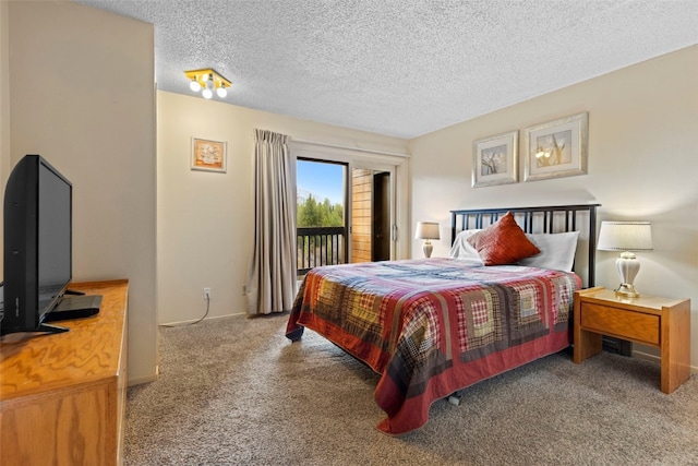 carpeted bedroom with access to outside, a textured ceiling, and baseboards