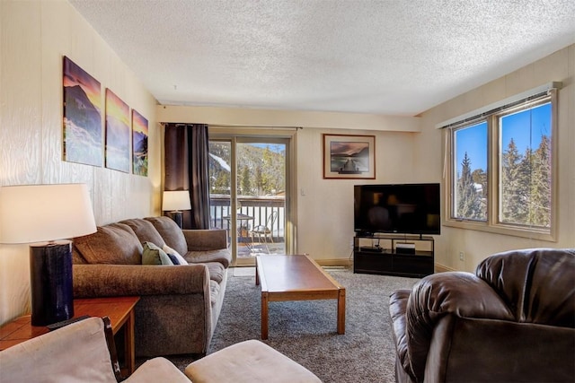 carpeted living room featuring a textured ceiling and baseboards