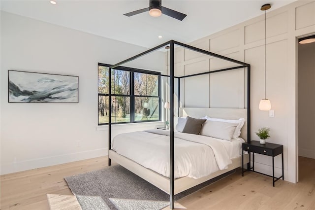 bedroom with ceiling fan and light hardwood / wood-style floors