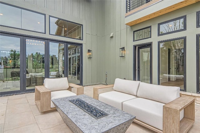 view of patio / terrace with an outdoor living space with a fire pit