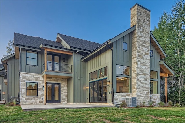 back of house with a patio, a yard, and french doors