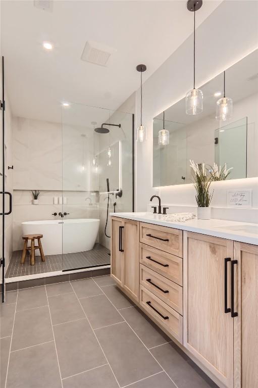 bathroom featuring independent shower and bath, tile patterned flooring, and vanity