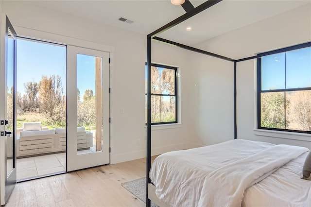 bedroom with access to outside and light hardwood / wood-style flooring