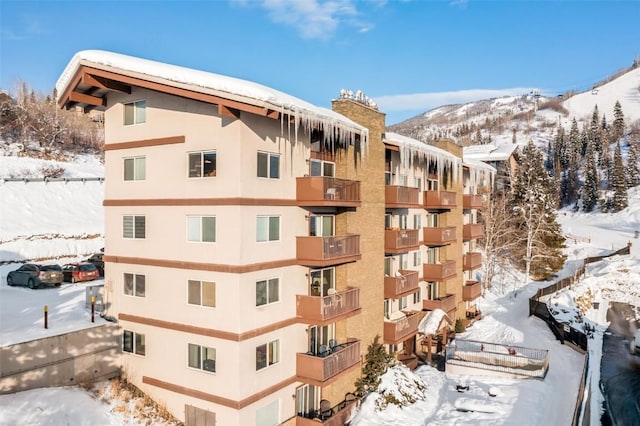 snow covered building with a mountain view