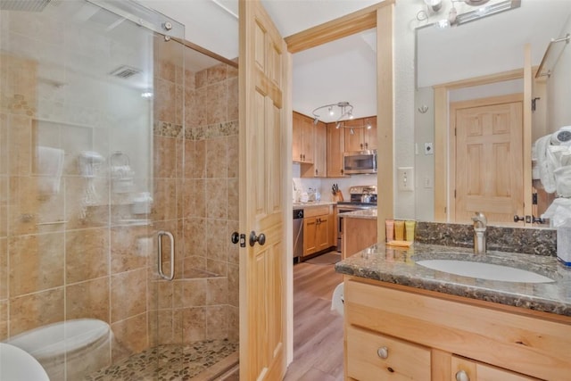 bathroom featuring vanity, a shower with door, and hardwood / wood-style floors