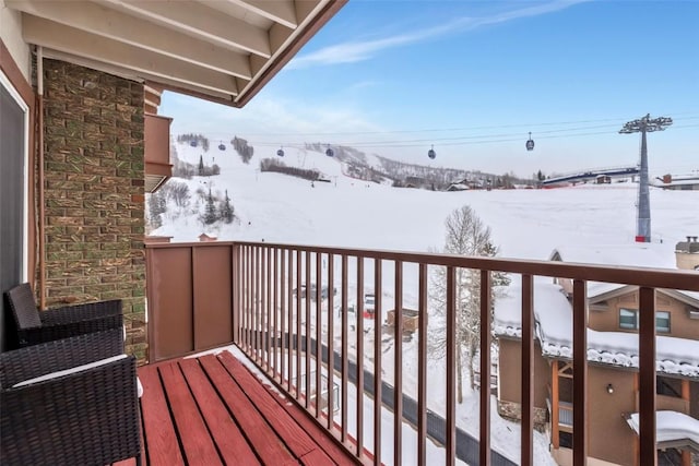 view of snow covered back of property