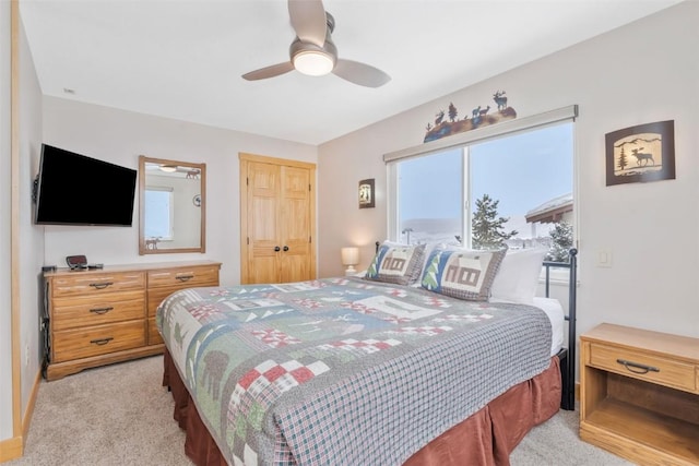 bedroom featuring ceiling fan, light colored carpet, and a closet