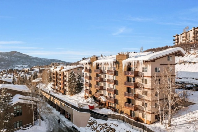 snow covered property with a mountain view