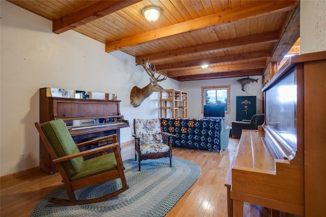 sitting room with beamed ceiling, wood-type flooring, and wooden ceiling