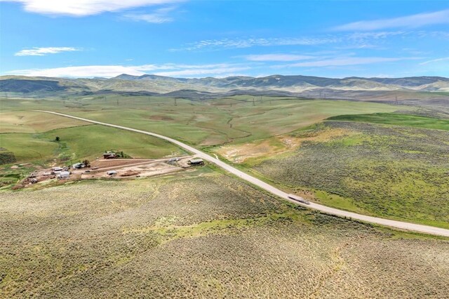 birds eye view of property featuring a mountain view and a rural view