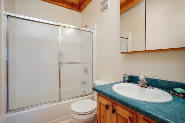 full bathroom with vanity, enclosed tub / shower combo, and toilet