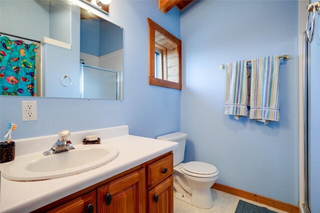 bathroom with a shower, vanity, and toilet