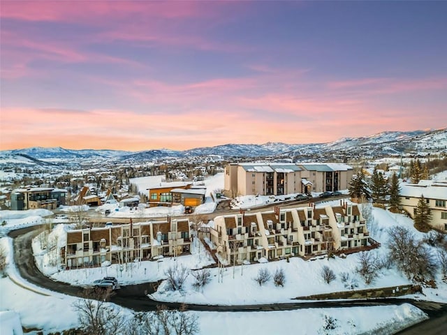 snowy aerial view with a mountain view