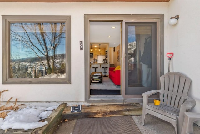 doorway to property featuring stucco siding