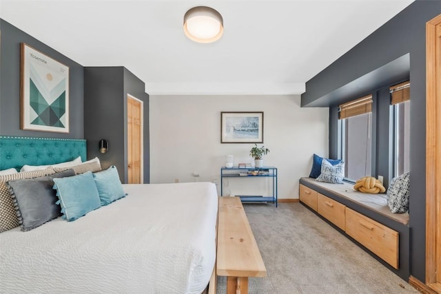 bedroom featuring light carpet and baseboards