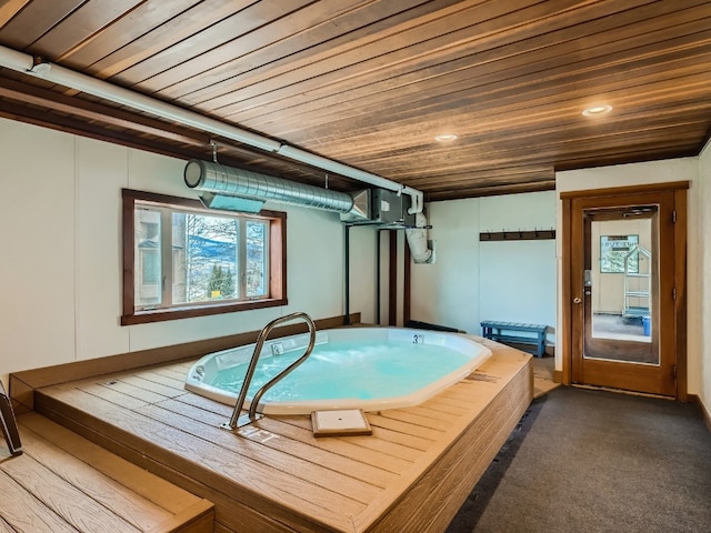 interior space featuring dark carpet, wooden ceiling, and a jacuzzi