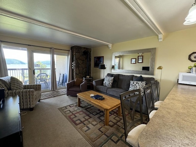 carpeted living room featuring beam ceiling