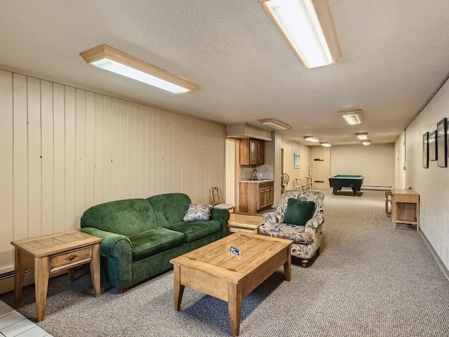 living room featuring light carpet, a textured ceiling, wood walls, and billiards