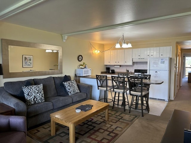 living room with a chandelier and carpet