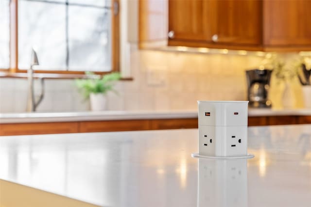 details featuring light countertops and brown cabinets