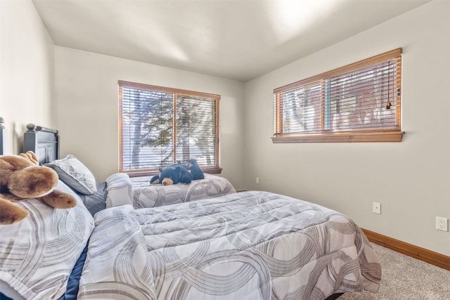 carpeted bedroom with baseboards