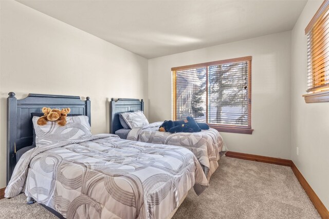 bedroom featuring carpet floors and baseboards