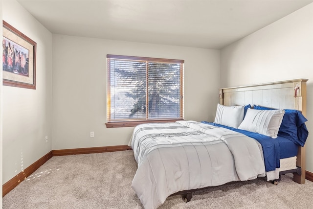 carpeted bedroom featuring baseboards