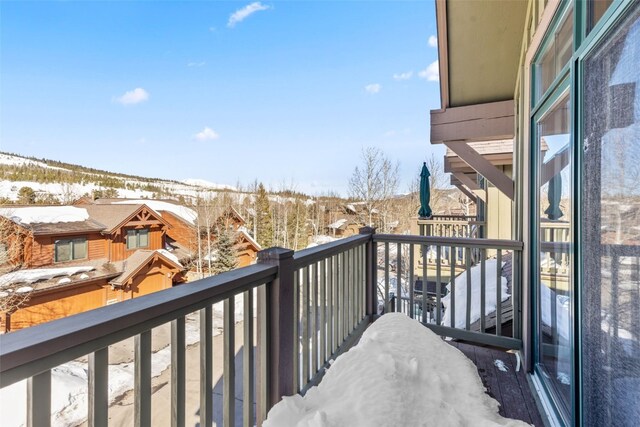 view of snow covered back of property