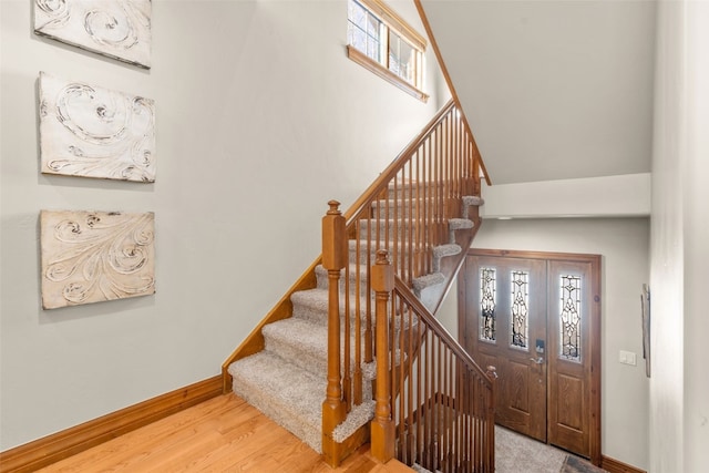 stairway featuring wood finished floors and baseboards