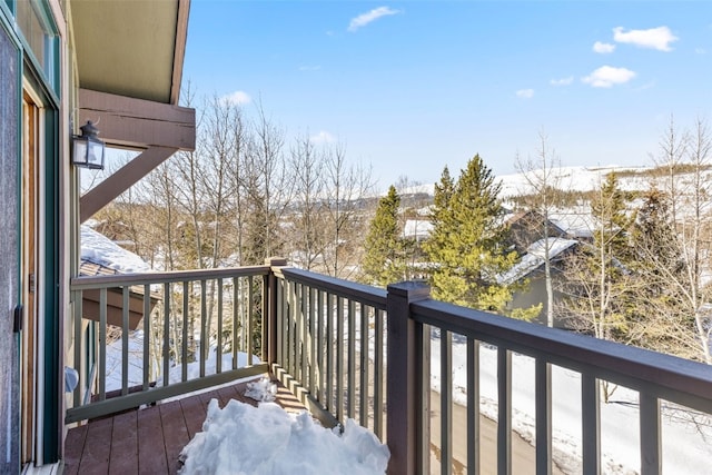 view of snow covered back of property