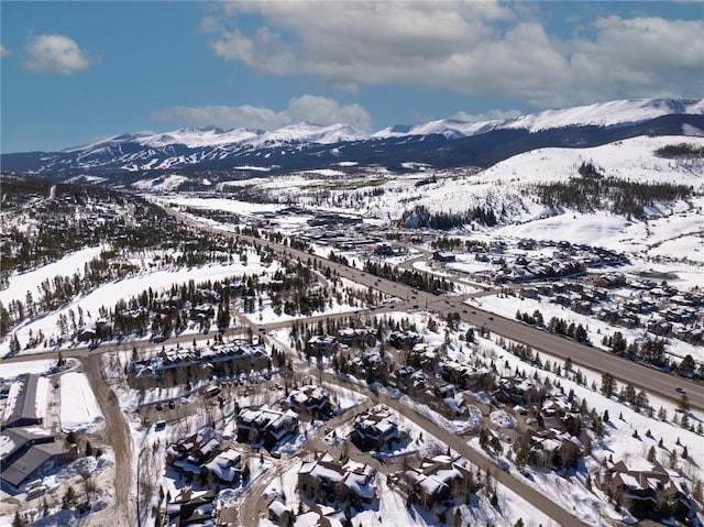 snowy aerial view featuring a mountain view