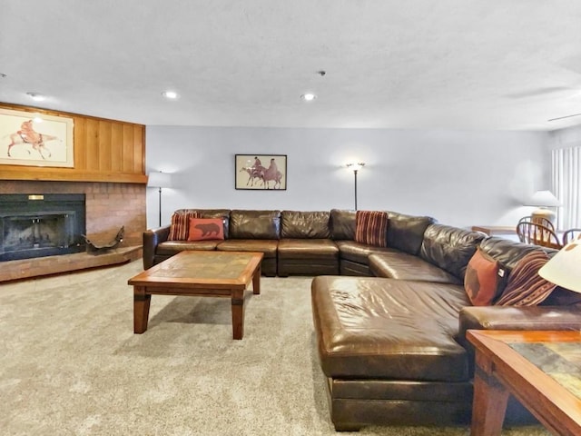 carpeted living room featuring a brick fireplace and recessed lighting