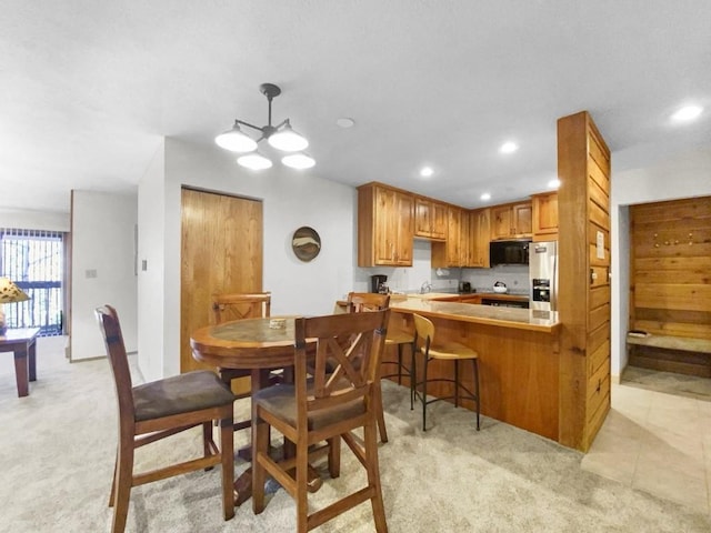 dining space with recessed lighting, light colored carpet, and light tile patterned floors