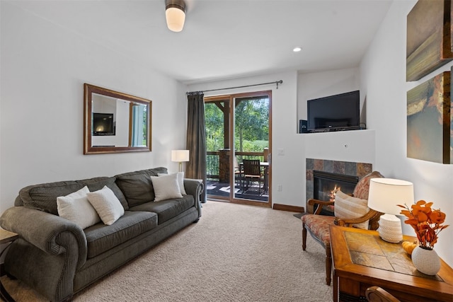 carpeted living room featuring a tile fireplace