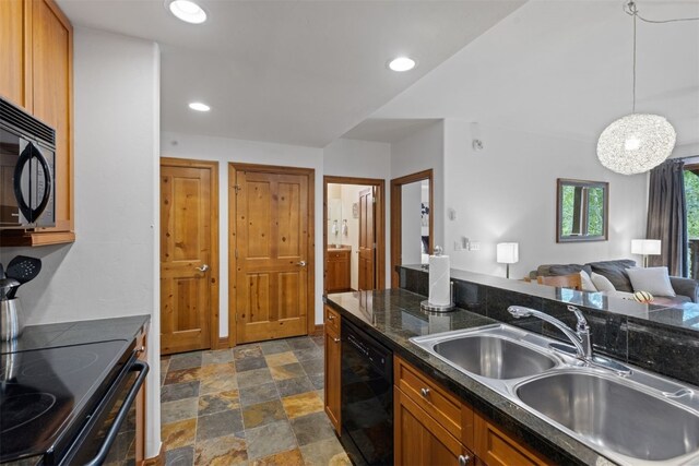 kitchen with black appliances, sink, and hanging light fixtures