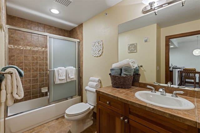 full bathroom with tile patterned floors, vanity, toilet, and enclosed tub / shower combo