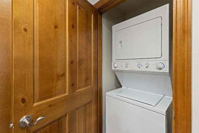 washroom featuring stacked washer / drying machine