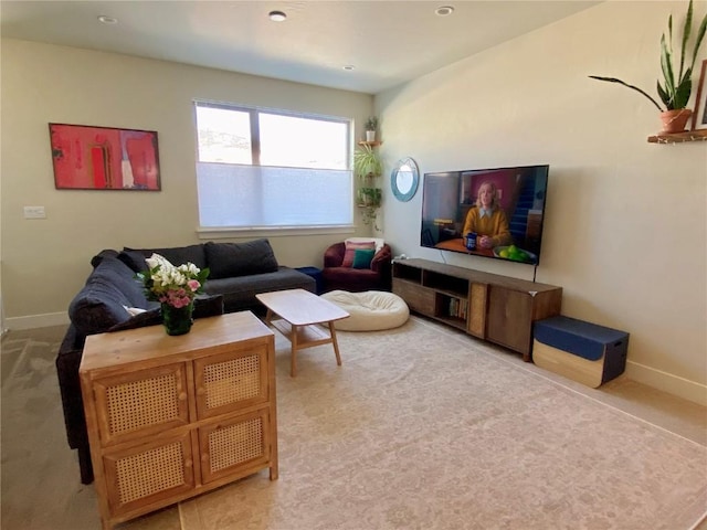 carpeted living area with baseboards