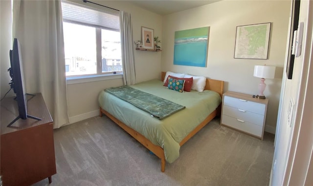 bedroom featuring carpet and baseboards