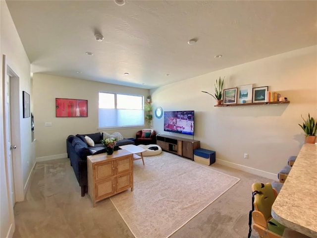 living room featuring baseboards and light carpet